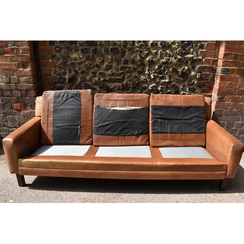 166 - A mid century design three-seater brown leather sofa, in the style of Georg Thams, with buttoned bac... 