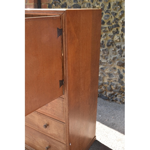 174 - A Heals limed oak cabinet, circa late 1930s, designed with forged iron exposed cabinet door hinges, ... 