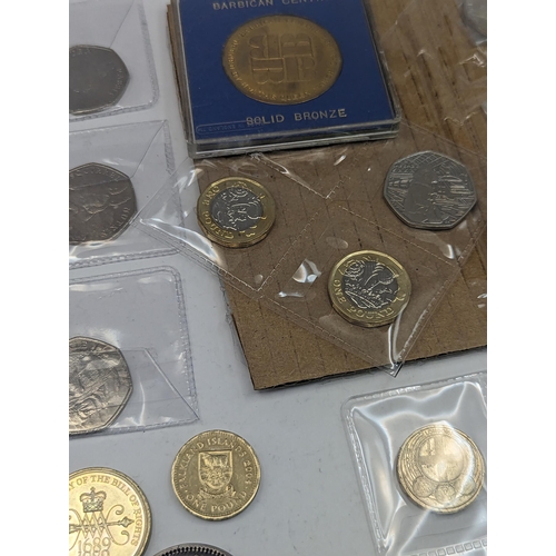 265 - A mixed collection of coins to include Beatrix Potter 50 pence, Paddington and others along with a m... 