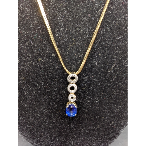 16 - A 9ct gold necklace together with a 9ct gold pendant set with a blue sapphire and paste stones, tota... 