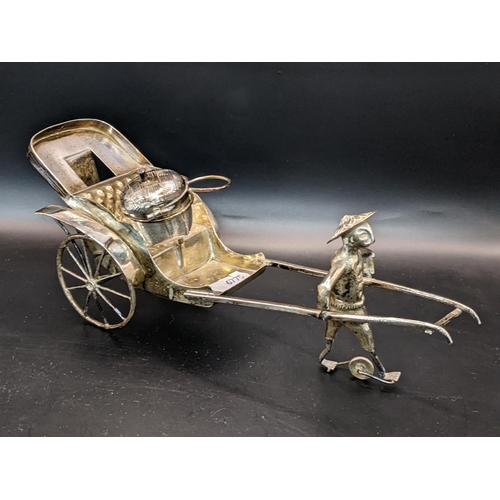 37 - A white metal Chinese cruet stand in the form of a Rickshaw being pulled by a man, 189.1g
Location:1... 