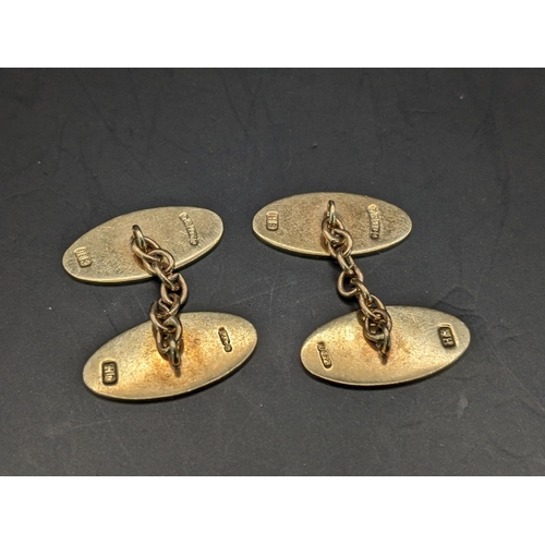 68 - A pair of 9ct gold cufflinks of oval form and having machine turned decoration, 5.9g
Location:CAB1