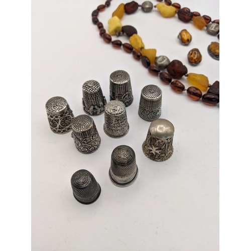 96 - A mixed lot to include an amber bead necklace and others, together with mixed silver thimbles to inc... 