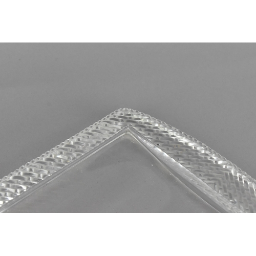 106 - A Lalique clear glass rectangular tray, post 1980, with woven pattern border, the underside with etc... 