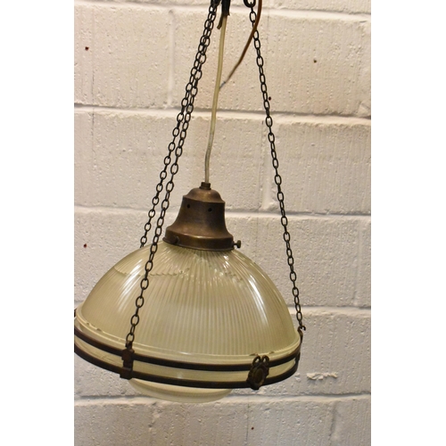 218 - A set of three brass mounted glass holophane pendant lights, each held on three chains joined to the... 