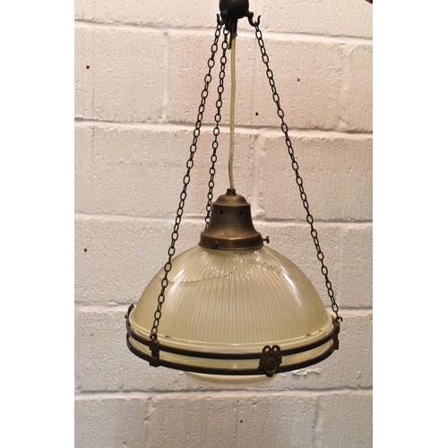 218 - A set of three brass mounted glass holophane pendant lights, each held on three chains joined to the... 