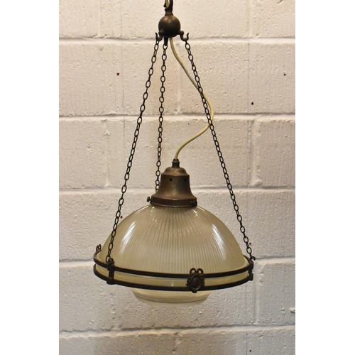 218 - A set of three brass mounted glass holophane pendant lights, each held on three chains joined to the... 