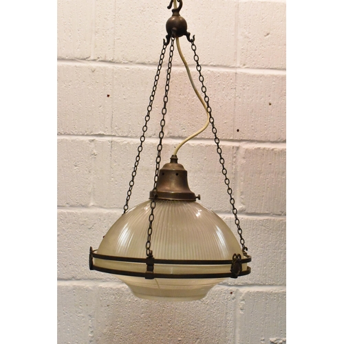 218 - A set of three brass mounted glass holophane pendant lights, each held on three chains joined to the... 