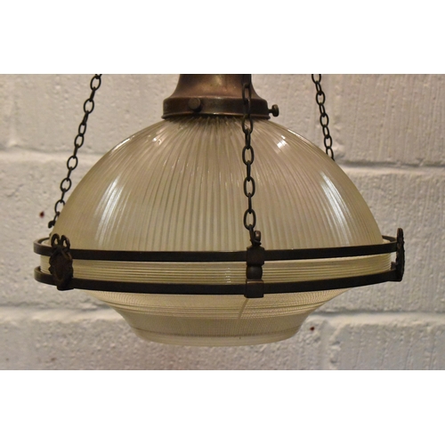 218 - A set of three brass mounted glass holophane pendant lights, each held on three chains joined to the... 