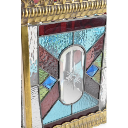 219 - A late Victorian Arts & Crafts stained glass hall lantern, of square section, brass mounted with fou... 