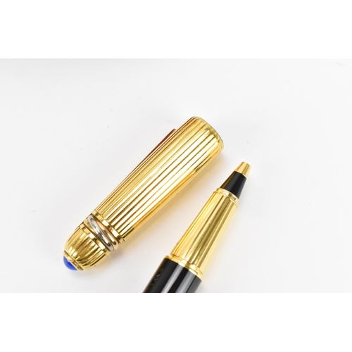 226 - Two Must De Cartier Stylo pens, one in gold plated mount numbered 005001, the other in gold colour a... 