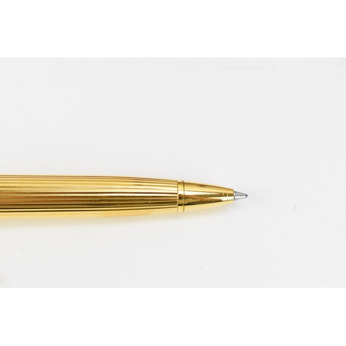 226 - Two Must De Cartier Stylo pens, one in gold plated mount numbered 005001, the other in gold colour a... 