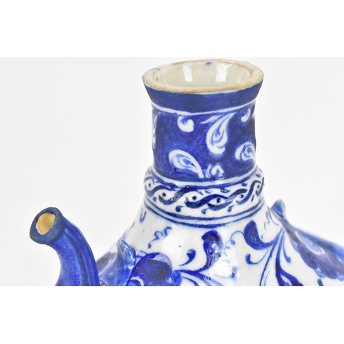 229 - A Turkish iznik style blue and white pottery water bottle, with foliate pattern and short spout, 17.... 