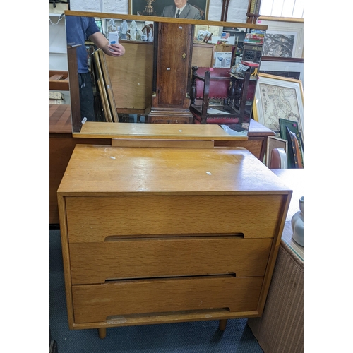 349 - A retro Stag 'C' range oak dressing chest of three drawers with mirror above, designed by John & Syl... 