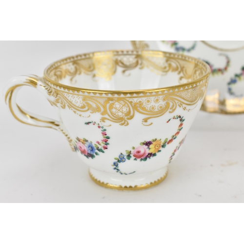 240 - An early 19th century French porcelain teacup and saucer, circa 1830, with Sevres gilt interlaced L ... 