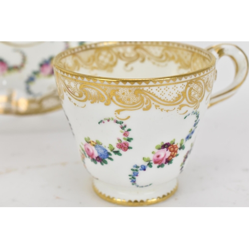 240 - An early 19th century French porcelain teacup and saucer, circa 1830, with Sevres gilt interlaced L ... 