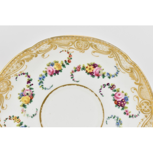 240 - An early 19th century French porcelain teacup and saucer, circa 1830, with Sevres gilt interlaced L ... 