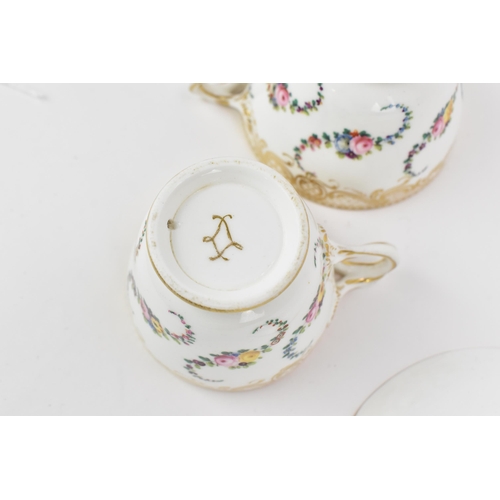 240 - An early 19th century French porcelain teacup and saucer, circa 1830, with Sevres gilt interlaced L ... 