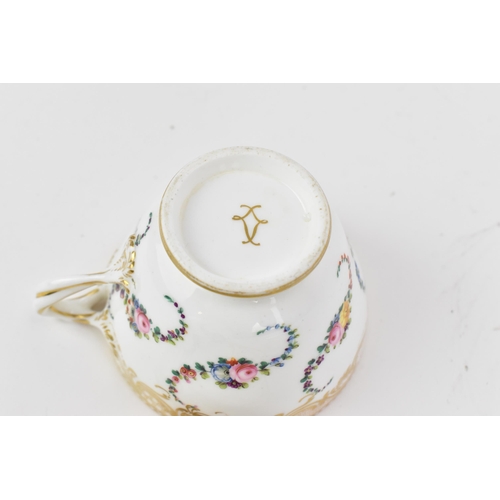 240 - An early 19th century French porcelain teacup and saucer, circa 1830, with Sevres gilt interlaced L ... 