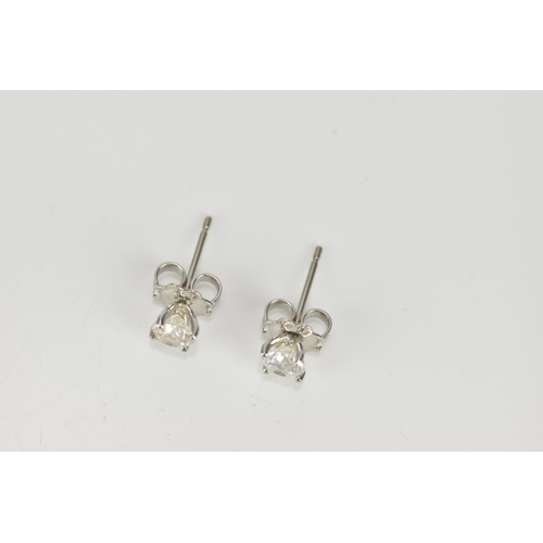 290 - A pair of solitaire diamond earrings, the brilliant cut stones approx 0.30 carat, in a four claw set... 