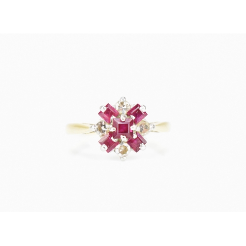 291 - An 18ct yellow gold, platinum, diamond and ruby floral cluster ring, set with five step cut rubies a... 