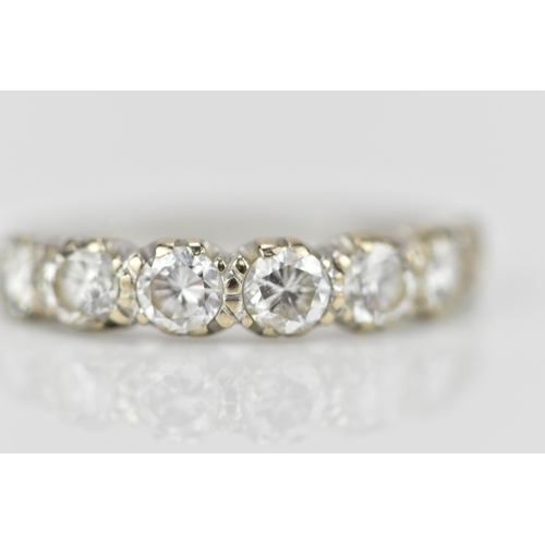 294 - An 18ct white gold seven stone diamond half eternity ring, the pave set round brilliant cut stones s... 