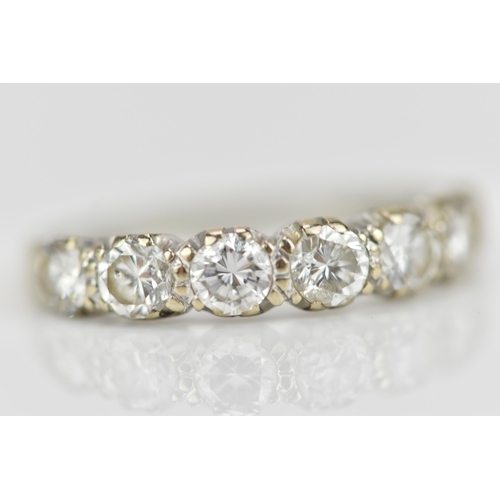 294 - An 18ct white gold seven stone diamond half eternity ring, the pave set round brilliant cut stones s... 