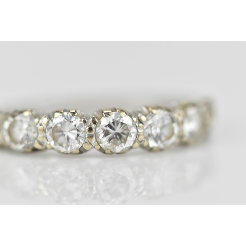 294 - An 18ct white gold seven stone diamond half eternity ring, the pave set round brilliant cut stones s... 