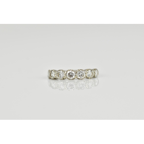 294 - An 18ct white gold seven stone diamond half eternity ring, the pave set round brilliant cut stones s... 