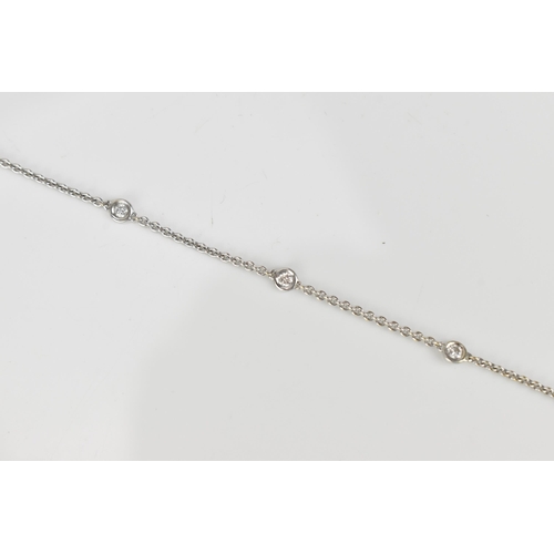 295 - An 18ct white gold and diamond bracelet, designed with a cable link chain with six interspersed beze... 