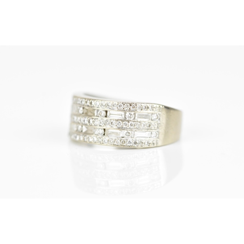 299 - An 18ct white gold and diamond set dress ring, designed with four alternating rows of pave set brill... 