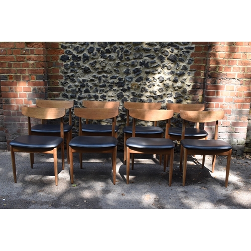 193 - A mid century extending teak dining table, d-ended, together with a set of eight dining chairs uphol... 