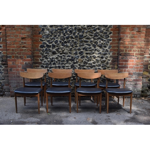 193 - A mid century extending teak dining table, d-ended, together with a set of eight dining chairs uphol... 