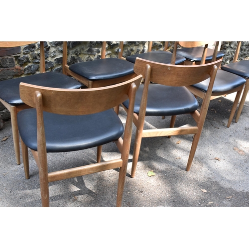 193 - A mid century extending teak dining table, d-ended, together with a set of eight dining chairs uphol... 