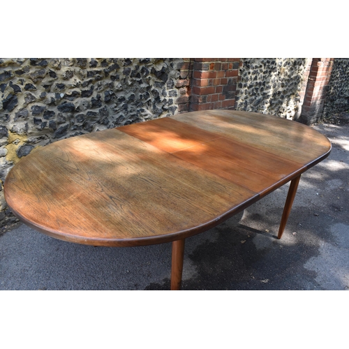 193 - A mid century extending teak dining table, d-ended, together with a set of eight dining chairs uphol... 