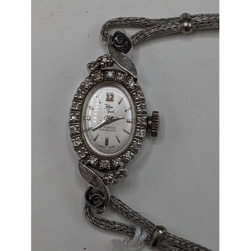 60 - A Filippe Girard manual wind, ladies 14k stamped white gold cased wristwatch inset with 24 diamonds,... 