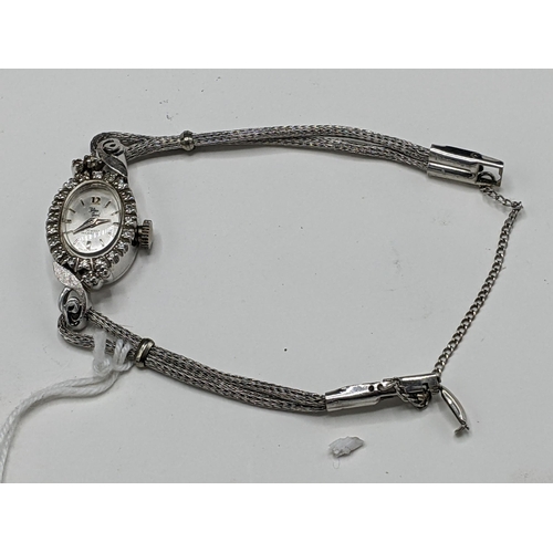 60 - A Filippe Girard manual wind, ladies 14k stamped white gold cased wristwatch inset with 24 diamonds,... 