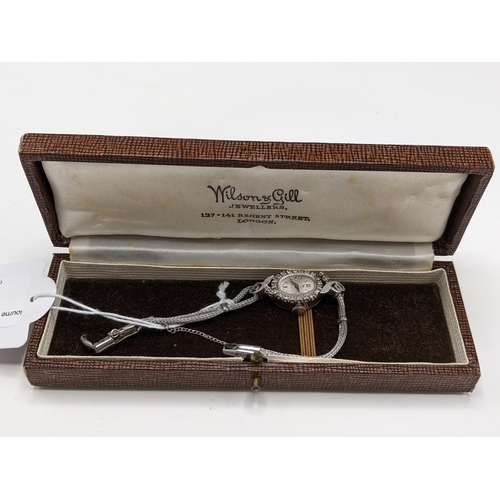 60 - A Filippe Girard manual wind, ladies 14k stamped white gold cased wristwatch inset with 24 diamonds,... 