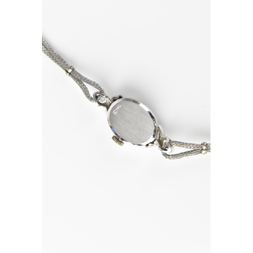 60 - A Filippe Girard manual wind, ladies 14k stamped white gold cased wristwatch inset with 24 diamonds,... 