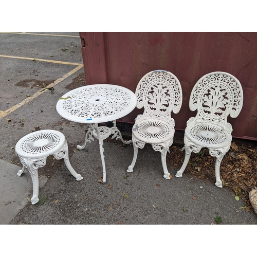 189 - A modern white painted cast metal garden table 68cm h x 68cm dia, and a matching pair of chairs and ... 