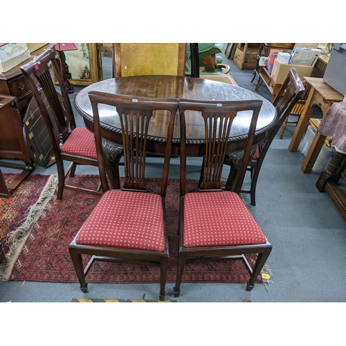 203 - A 1920s Mahogany extending dinning table with extra leaf, 75h x 137W unextended together with a set ... 