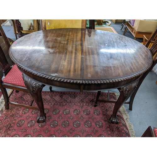 203 - A 1920s Mahogany extending dinning table with extra leaf, 75h x 137W unextended together with a set ... 