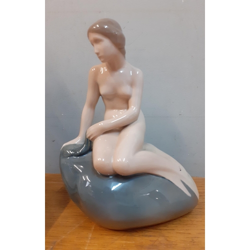 211 - Four late 20th Century figures comprising a Royal Copenhagen 'Little Mermaid', 2 small Lladro figure... 