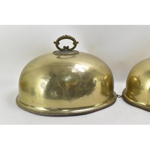 422 - A graduated set of Victorian brass meat covers, with beaded rim and hoop handles, the front of each ... 