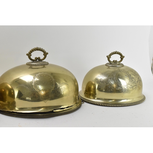 422 - A graduated set of Victorian brass meat covers, with beaded rim and hoop handles, the front of each ... 