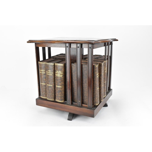 423 - An Edwardian mahogany table top revolving bookcase, with serpentine moulded edge and inlaid with str... 