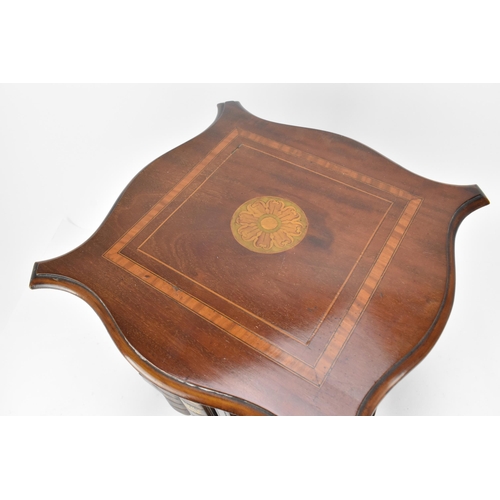 423 - An Edwardian mahogany table top revolving bookcase, with serpentine moulded edge and inlaid with str... 