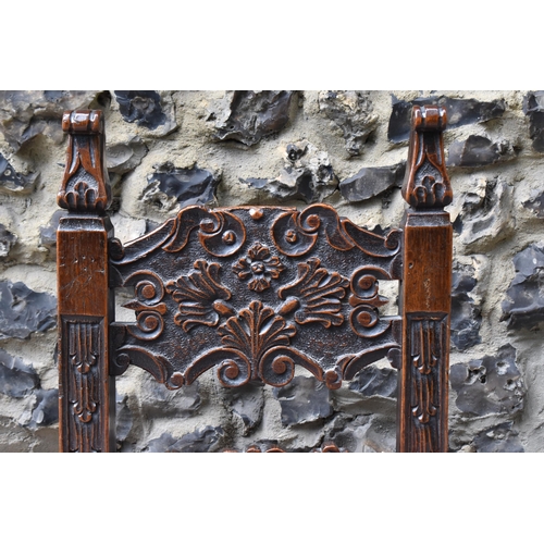 427 - A 17th/18th century carved oak Derbyshire style correction chair, with pierced shaped cresting rail ... 