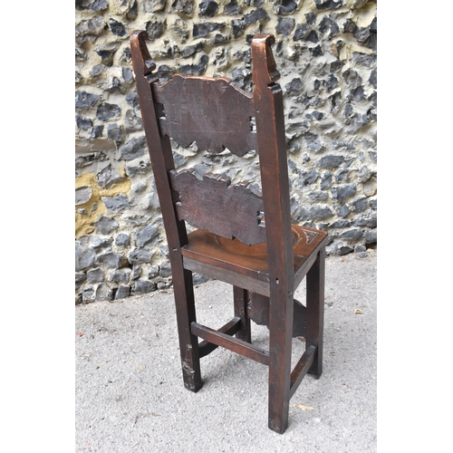 427 - A 17th/18th century carved oak Derbyshire style correction chair, with pierced shaped cresting rail ... 