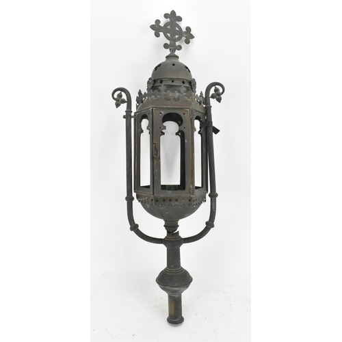 387 - A Gothic Revival wrought iron lantern, of hexagonal form with arched openings, surmounted with fleur... 